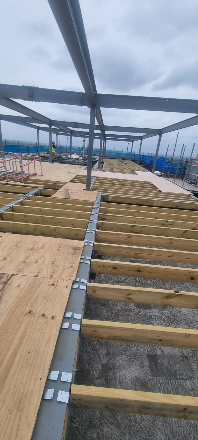 New timber floor joists connected to steel beams