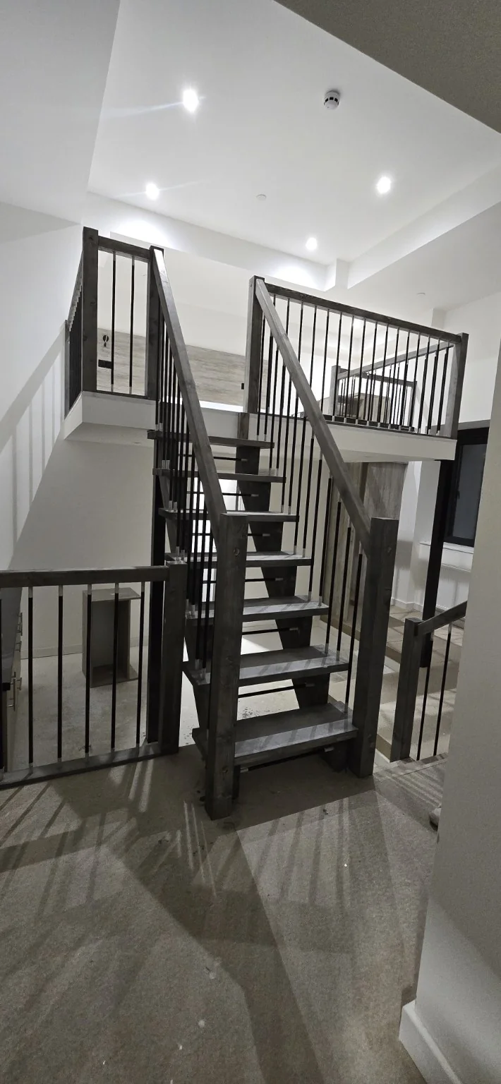 Finished stairway with timber detailing and dark balustrades