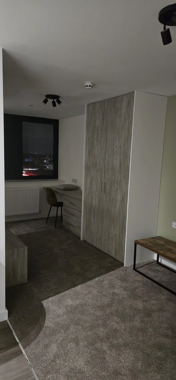 Finished studio living area and fitted storage