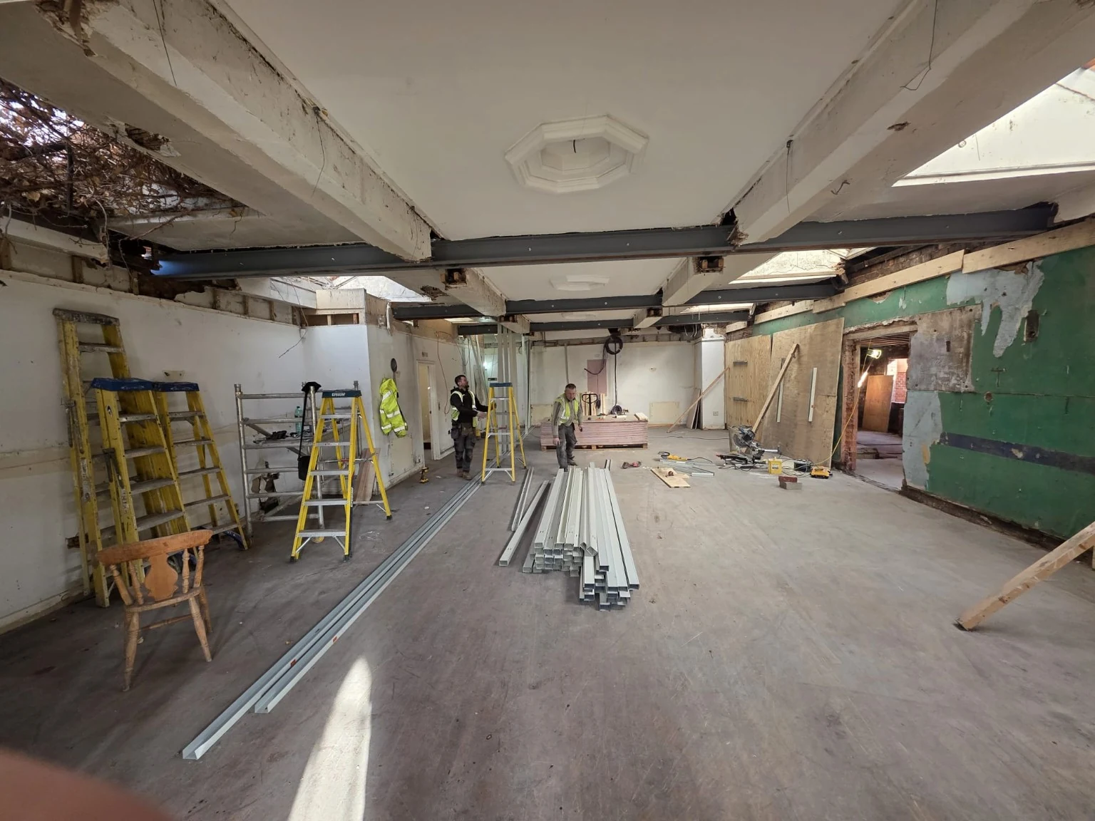 Multiple new steel beams across a large interior under refurbishment